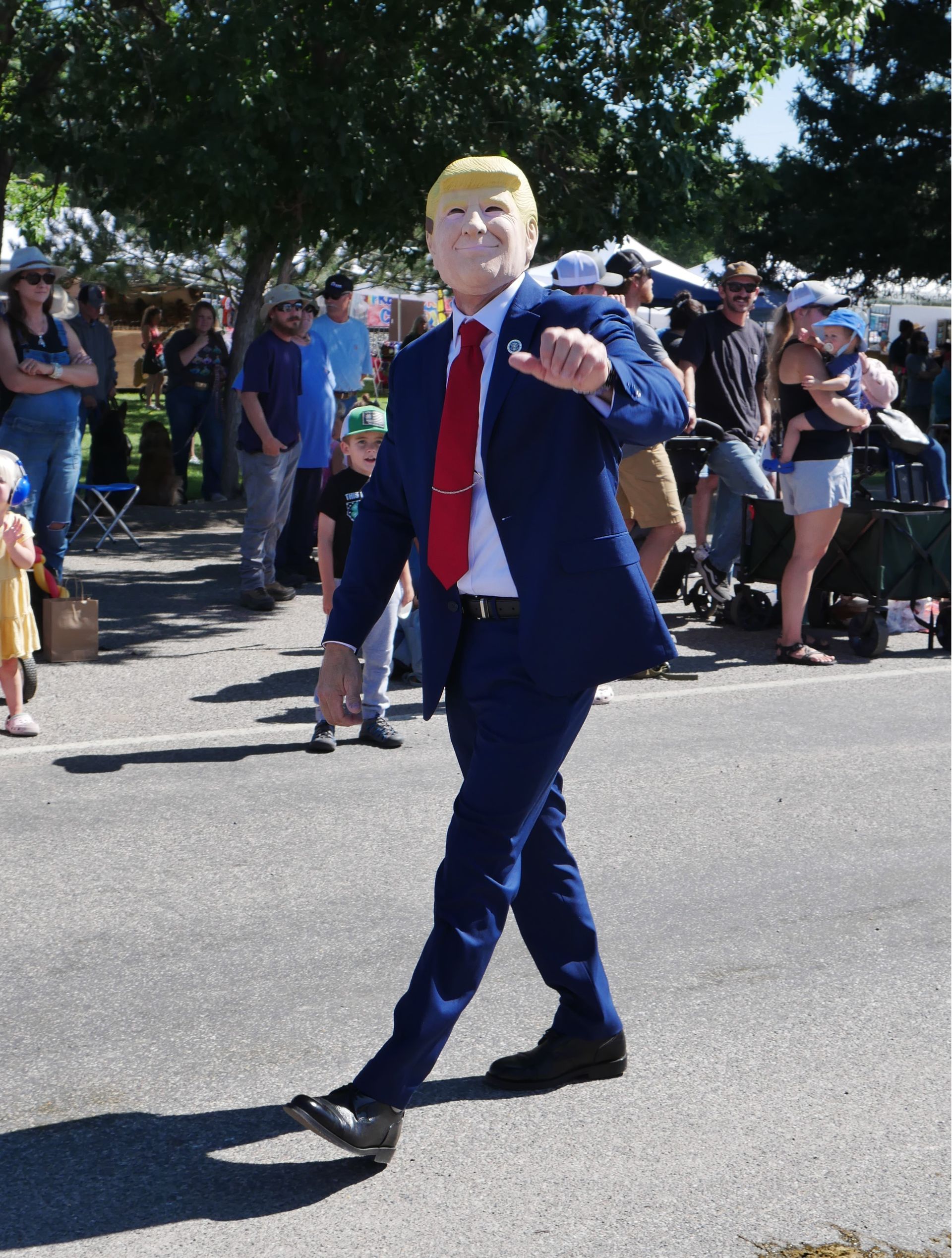 A man in a suit and tie is walking down the street