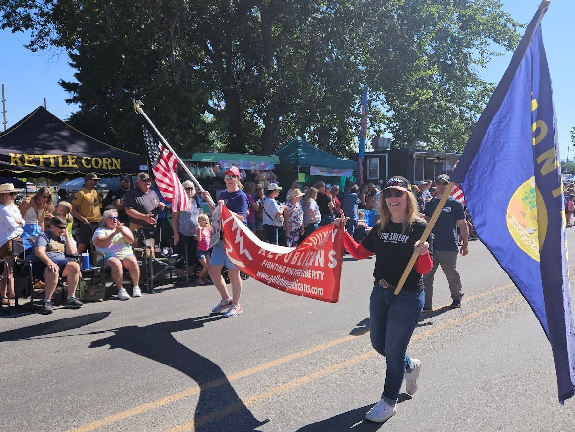 A woman in a parade holding a banner that says better corn
