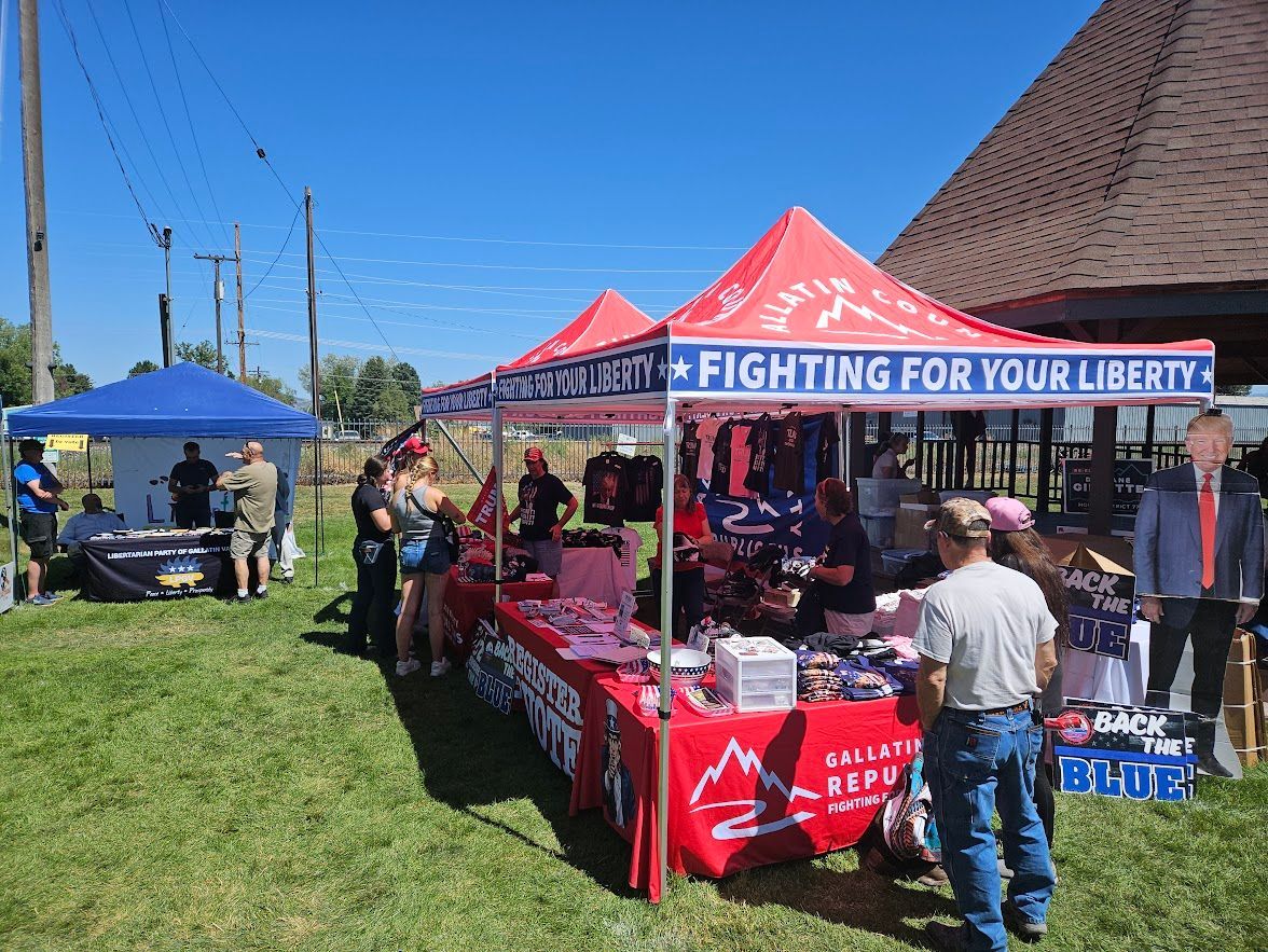A group of people are standing under a tent that says fighting for your liberty.