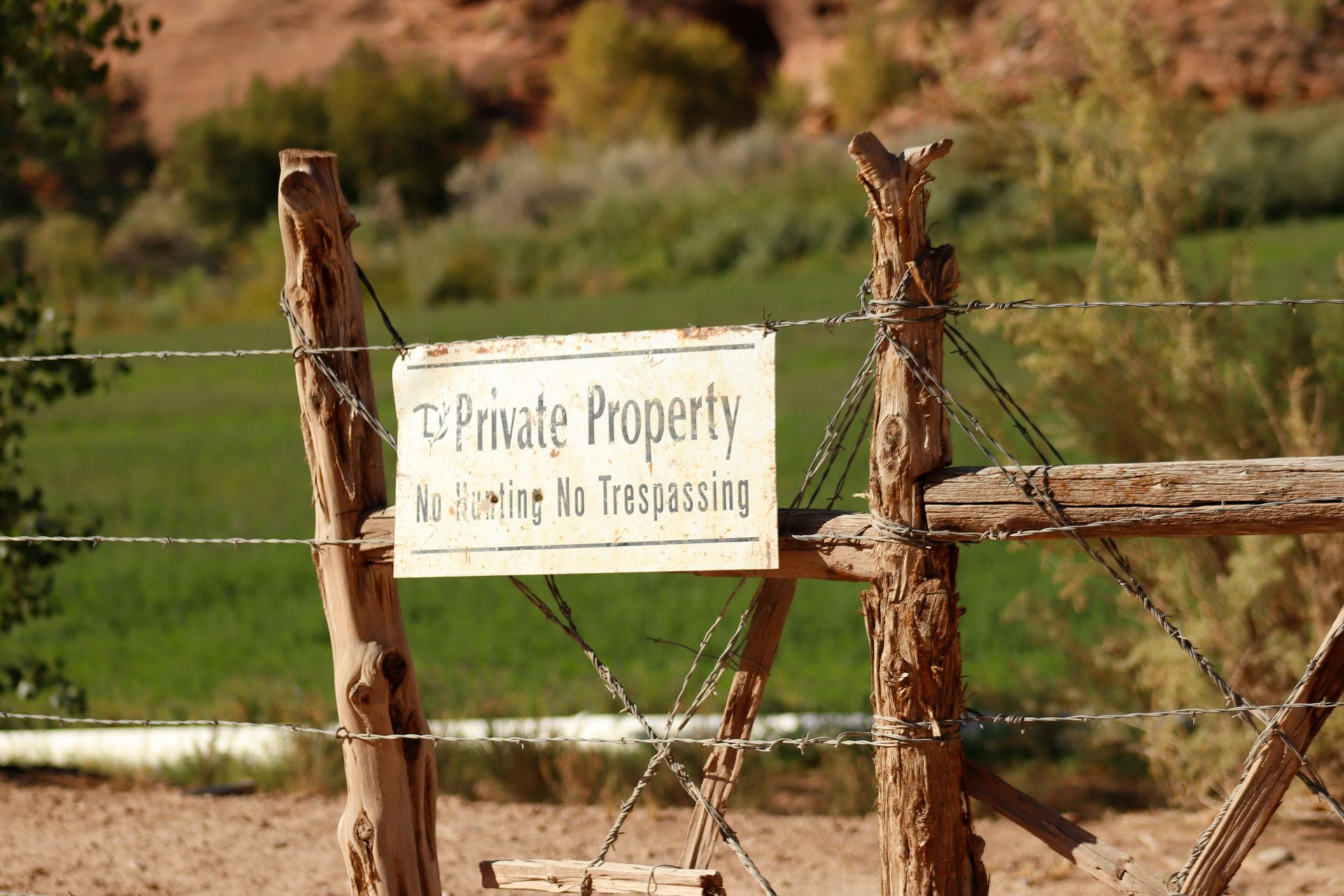 A wooden fence with a sign that says private property