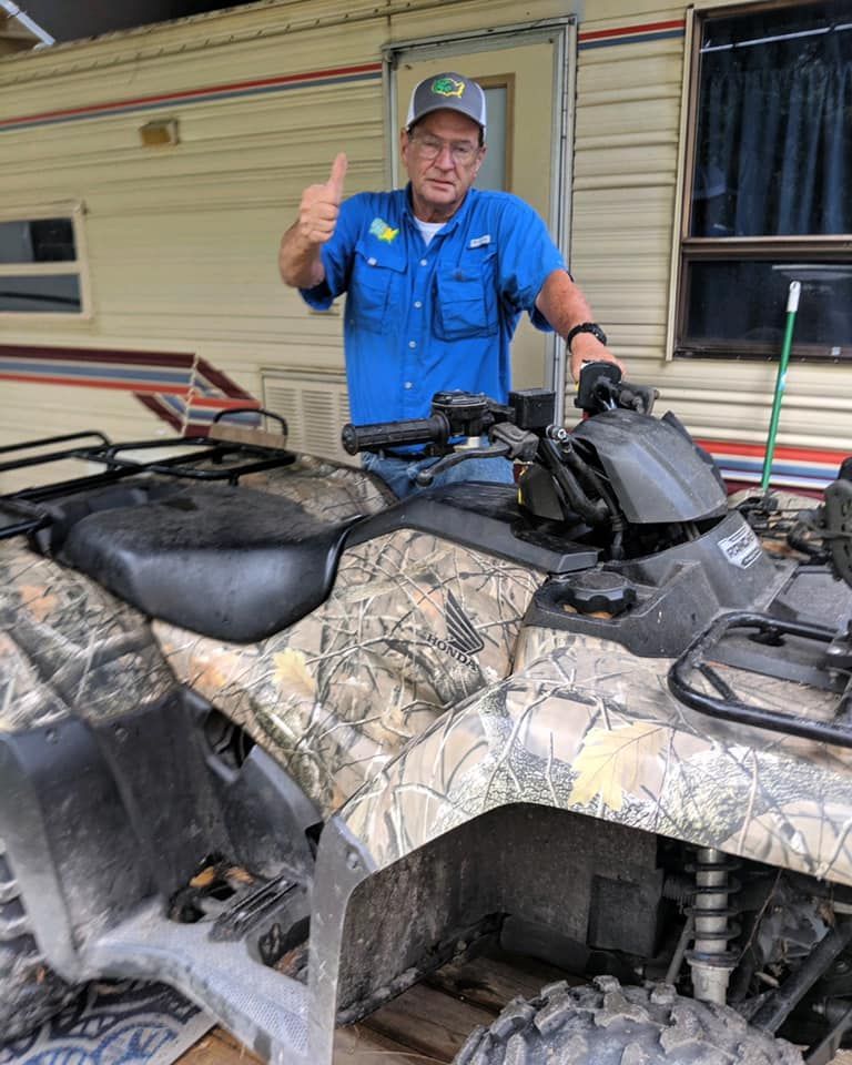 A man is standing next to an ATV and giving a thumbs up — St. Augustine, FL — Wide Open Mobile Tech