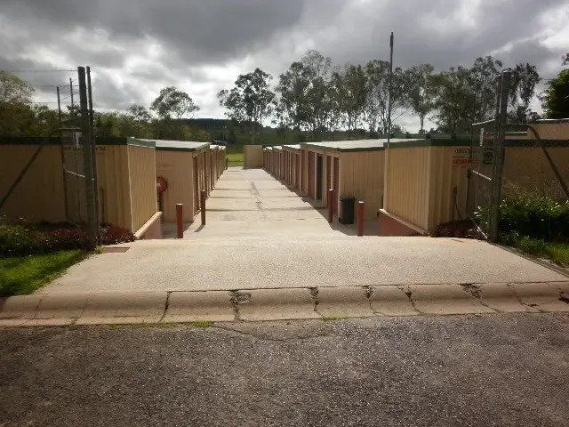 A Concrete Walkway Leading to a Row of Storage Units — Tableland Self Storage In Atherton, QLD