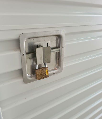 A Metal Door With a Padlock on It — Tableland Self Storage In Atherton, QLD