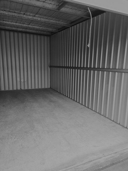A Black and White Photo of an Empty Garage With a Concrete Floor — Tableland Self Storage In Atherton, QLD