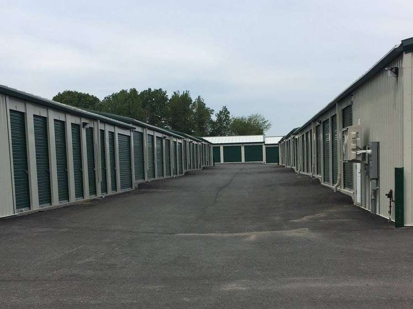 a row of storage units are lined up in a parking lot