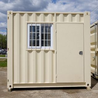 a shipping container with a window and a door .