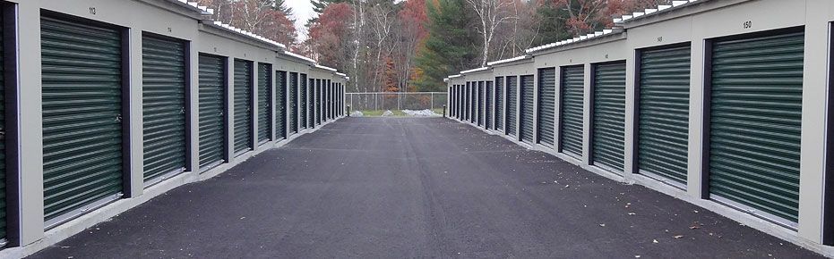 a row of storage units are lined up on the side of a road .