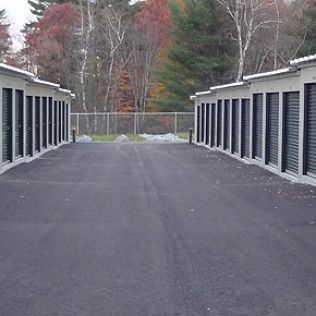 a row of storage units lined up on the side of a road