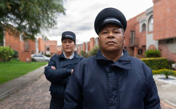 A man and a woman are standing next to each other on a sidewalk.