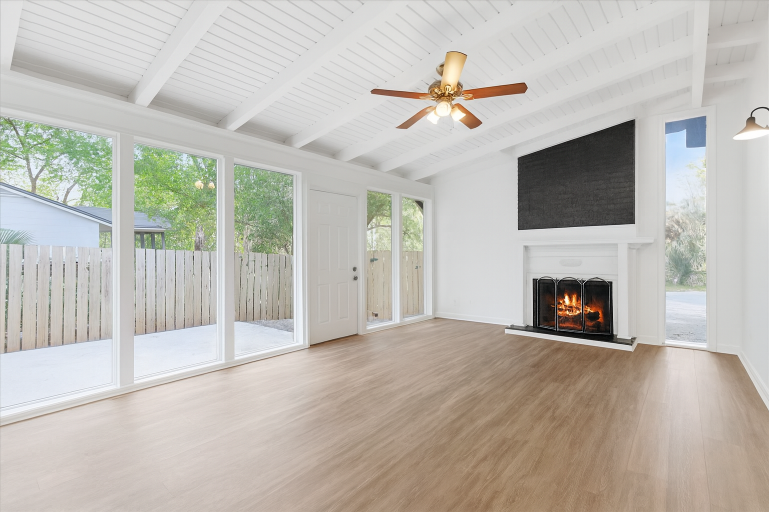 A young woman looks at her smartphone with her dog.
