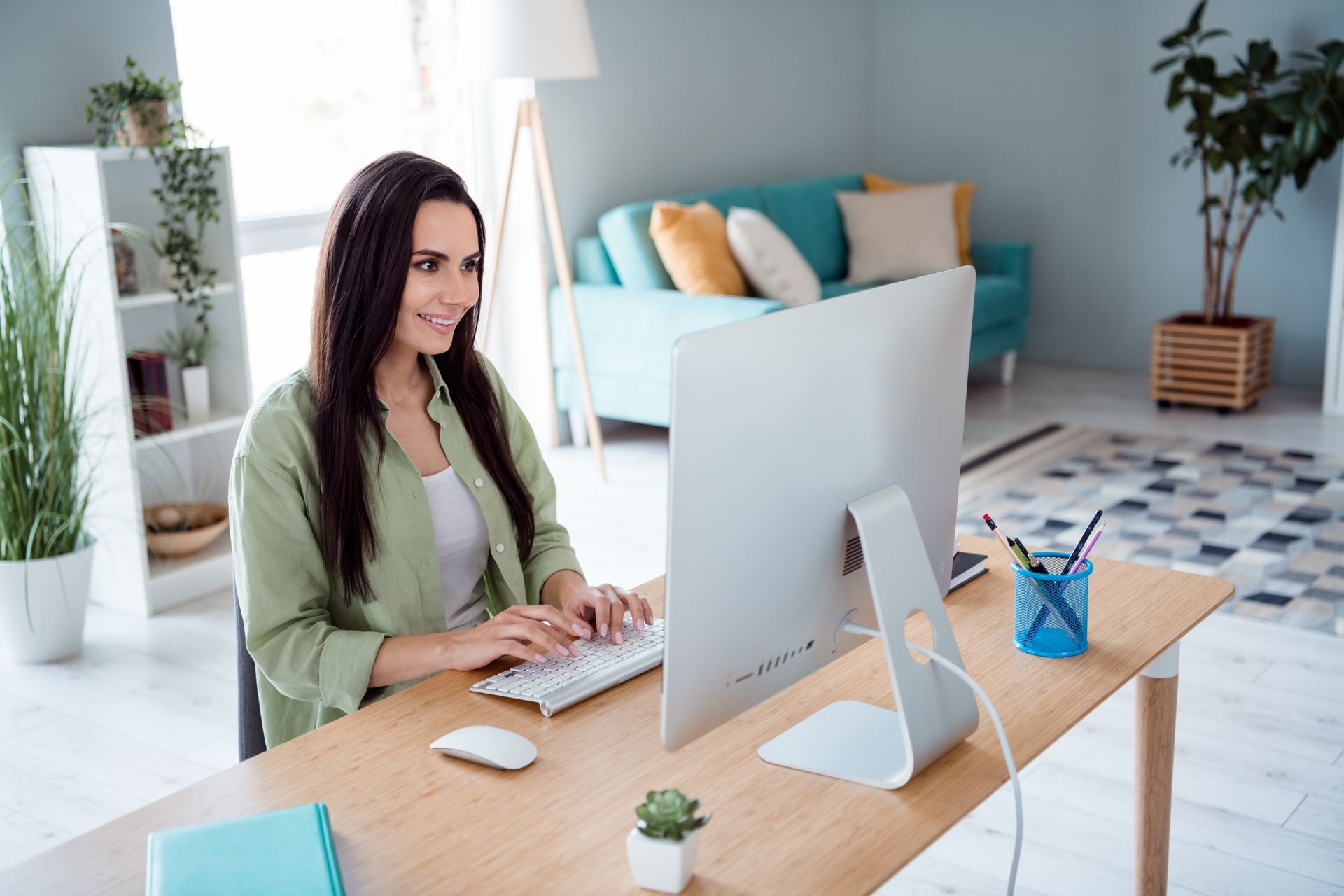 a woman is sitting at a desk in front of a computer .