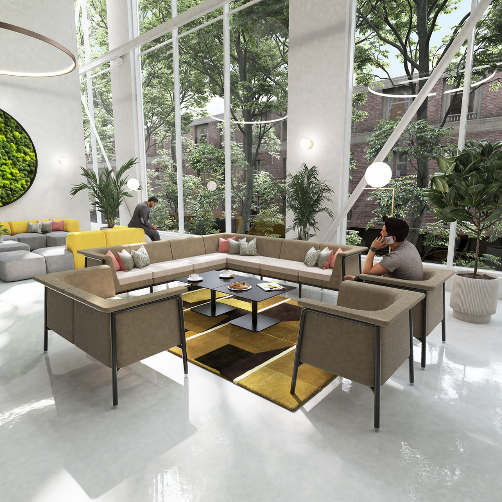 a man sits in a living room with a couch and chairs