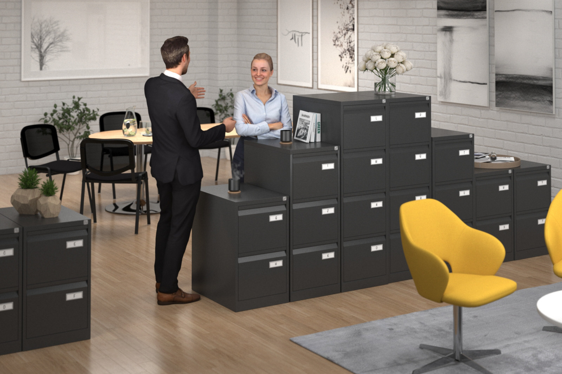 a man and a woman are standing in an office talking to each other .