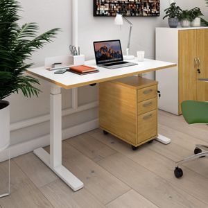 a standing desk with a laptop on it in a room .