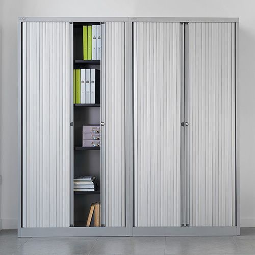 a metal cabinet with sliding doors and shelves filled with books and binders .