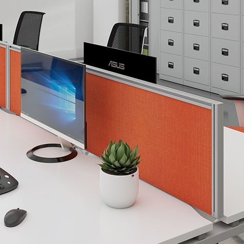 a computer monitor is sitting on a desk next to a potted plant .