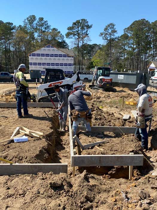 A group of construction workers are working on a construction site.