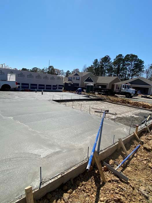 A concrete driveway is being built in front of a building