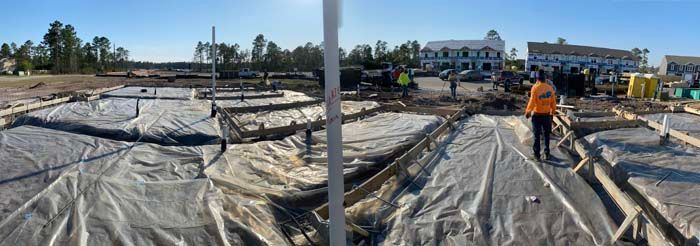 A man is standing on a construction site covered in plastic.