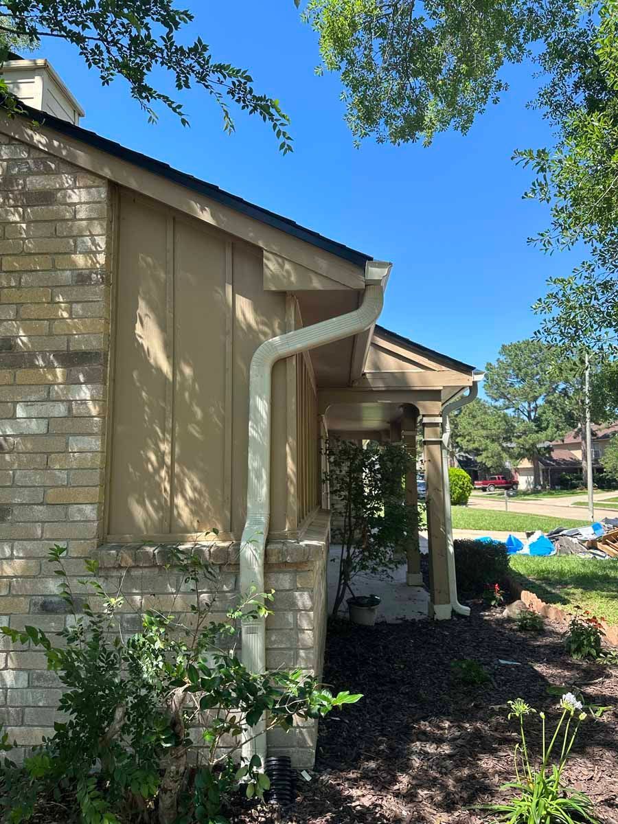 A house with a gutter on the side of it.