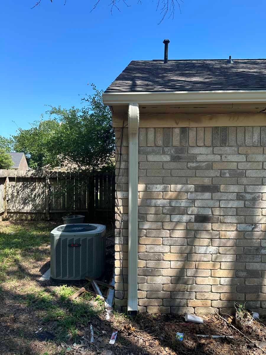 A brick building with an air conditioner on the side of it.