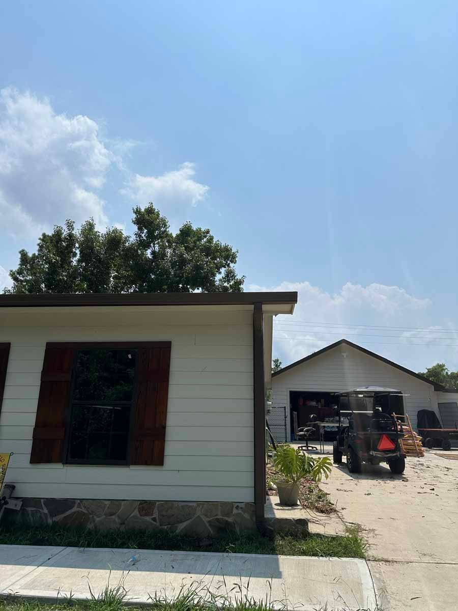 A white house with a jeep parked in front of it.
