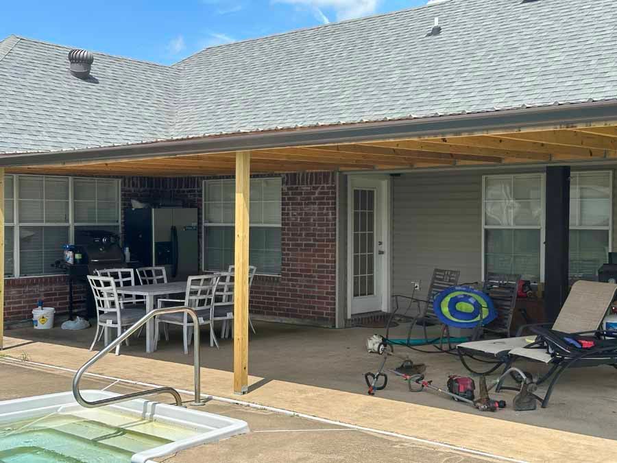 There is a swimming pool in the backyard of a house.
