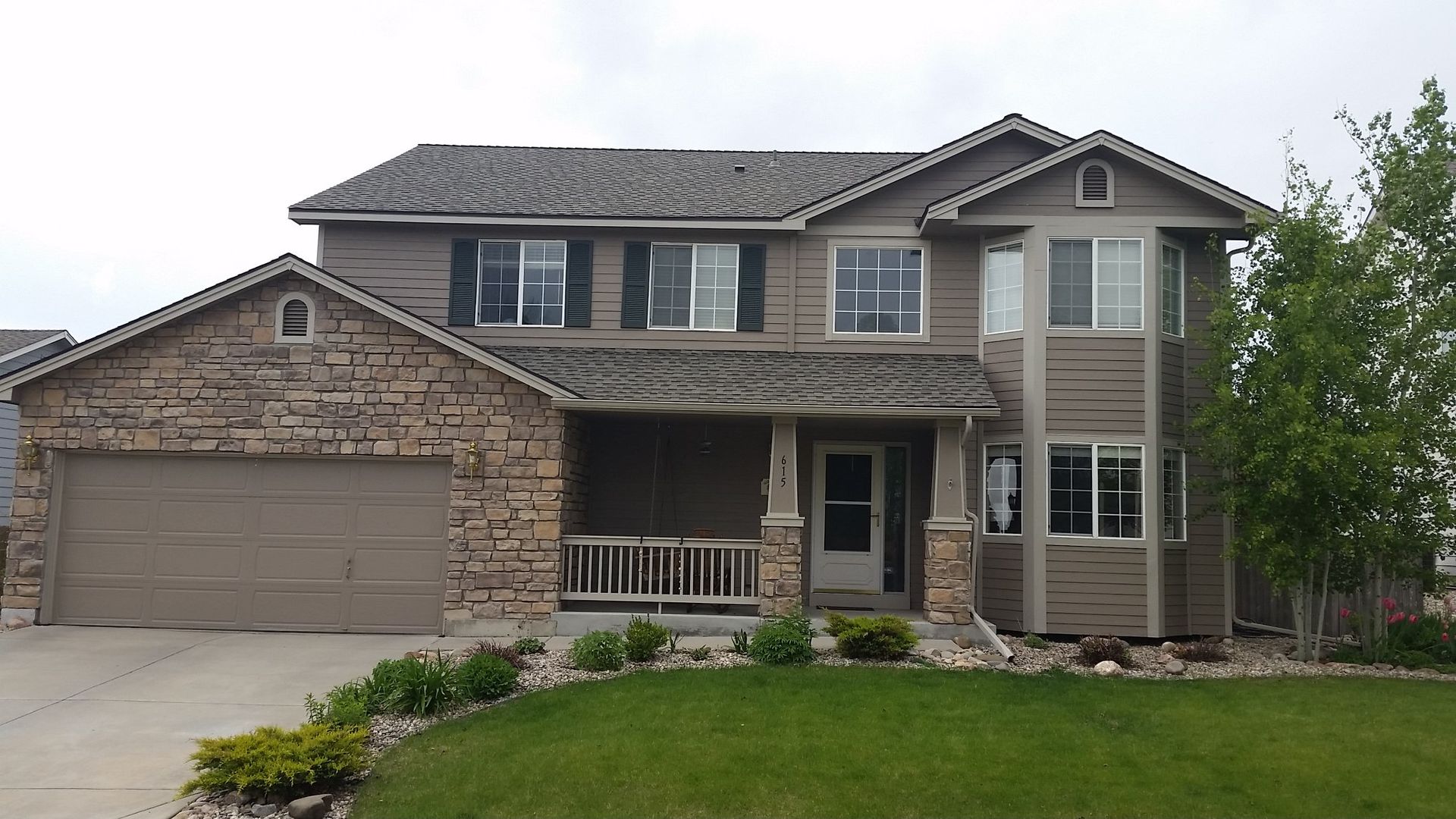 A large house with a lot of windows and shutters