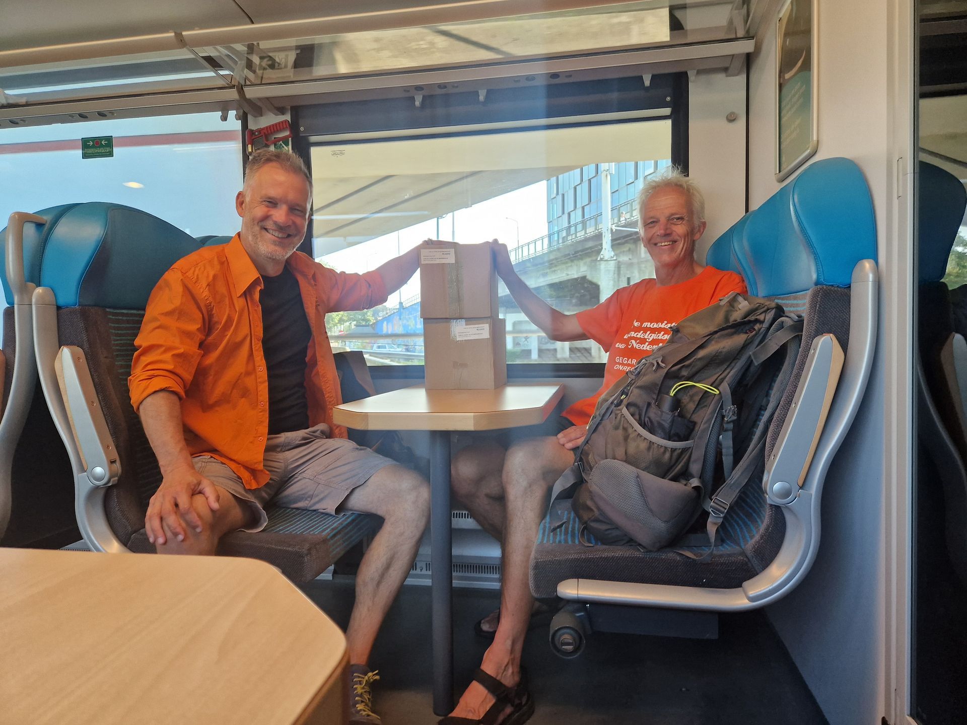 Uitgevers Bart van der Mark en Lourens Vellinga in de trein onderweg naar een presentatie