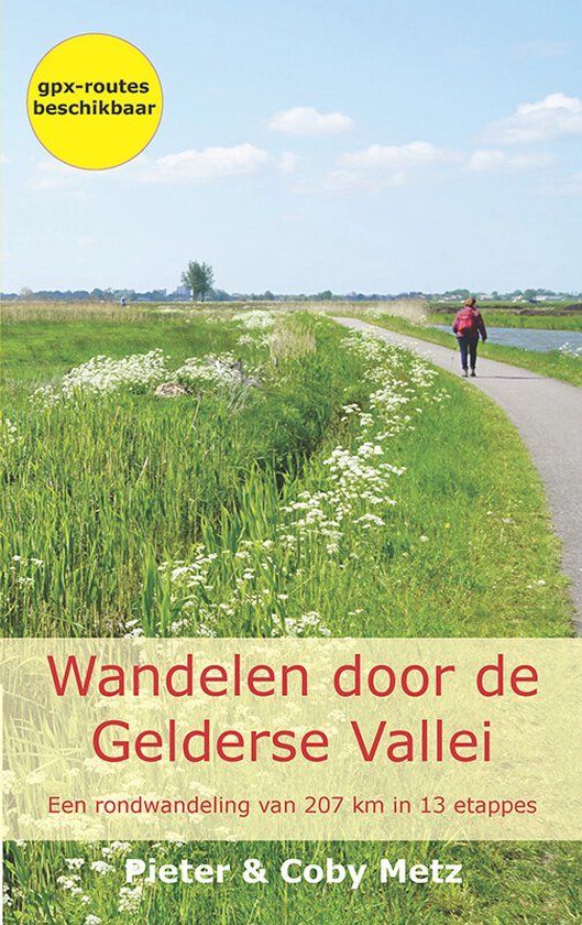 Boekcover: Een persoon loopt over een pad in een veld. Titel: Wandelen door de Gelderse Vallei.
