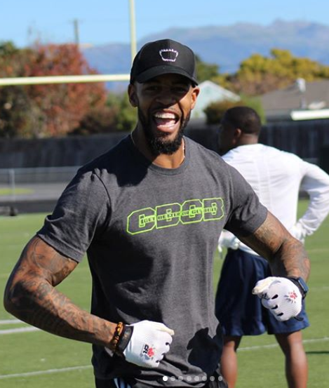 a man, Coach Mo wearing a gray shirt with the word GBGB on it