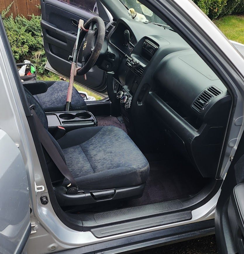 The inside of a silver car with the door open