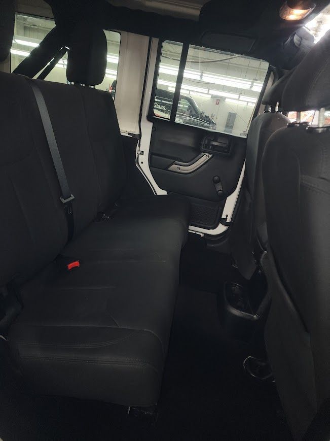 The back seat of a jeep with the door open