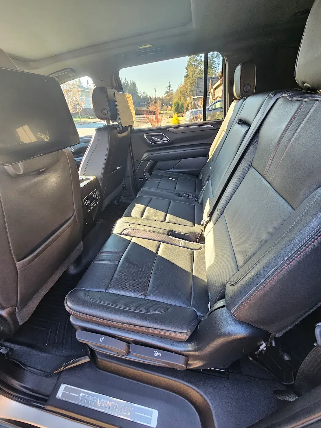 The back seat of a car with the seats folded down.