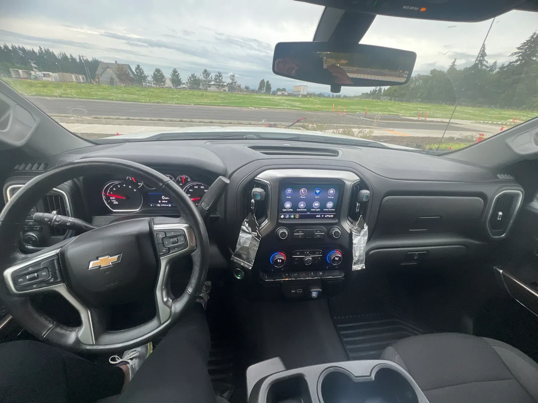 A person is sitting in the driver 's seat of a truck.