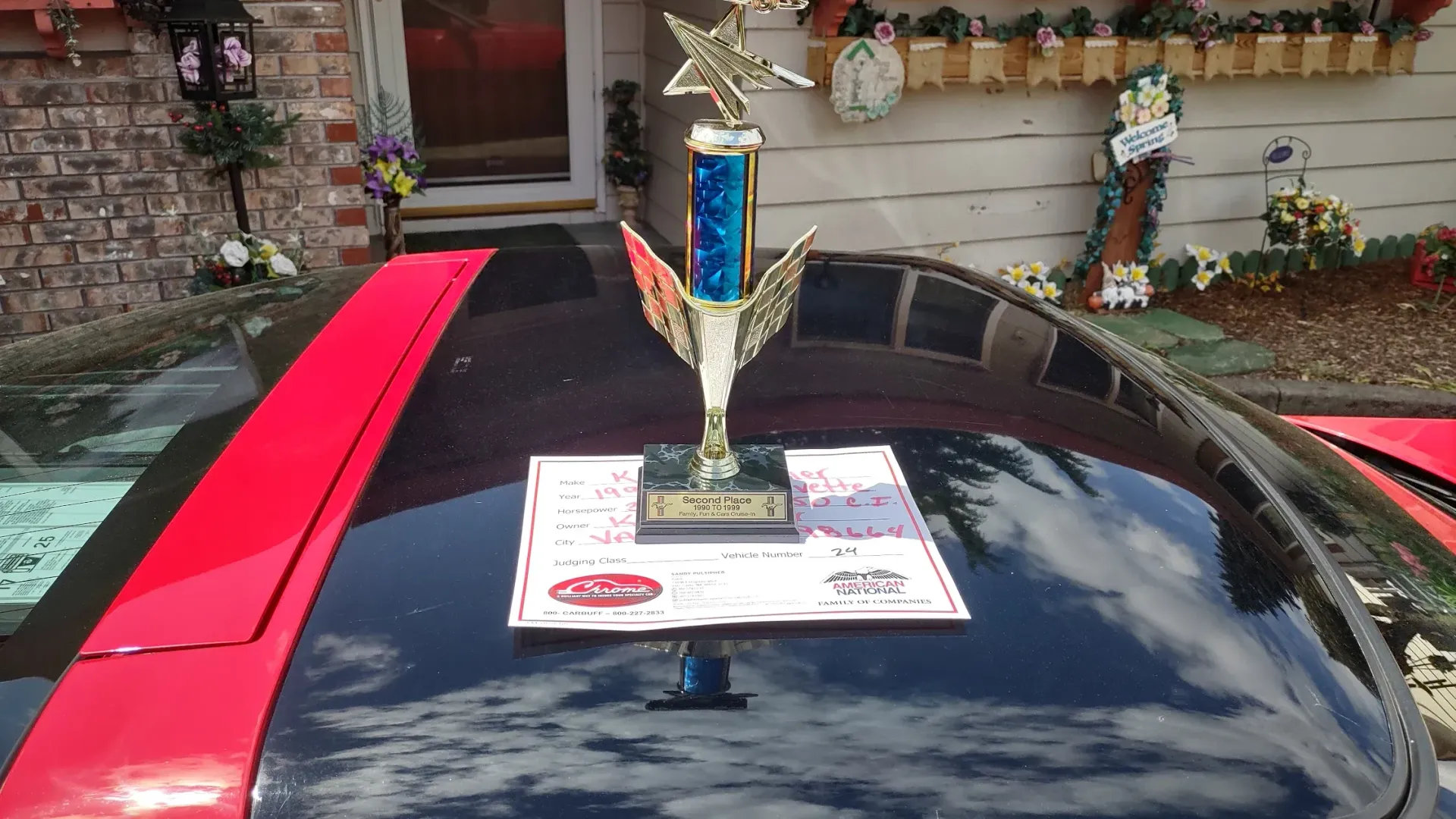 A trophy is sitting on the hood of a car