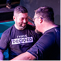 Two men in boxing gloves face off in a gym, one with “I MAY HAVE DEFEATED…” on his shirt.