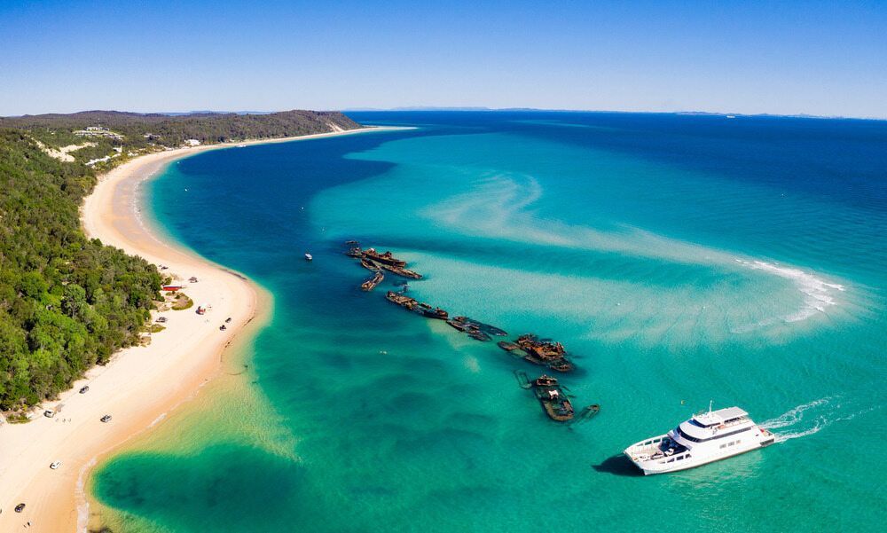 An Aerial View of a Boat in the Ocean Near a Beach — Branch Manager Tree Services Coolum Beach In Moreton Bay, QLD