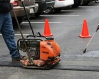 Man Repairing A Parking Lot — Pavement Sealing in El Paso, TX
