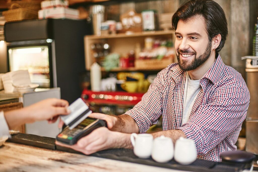 A man is paying with a credit card in a restaurant.