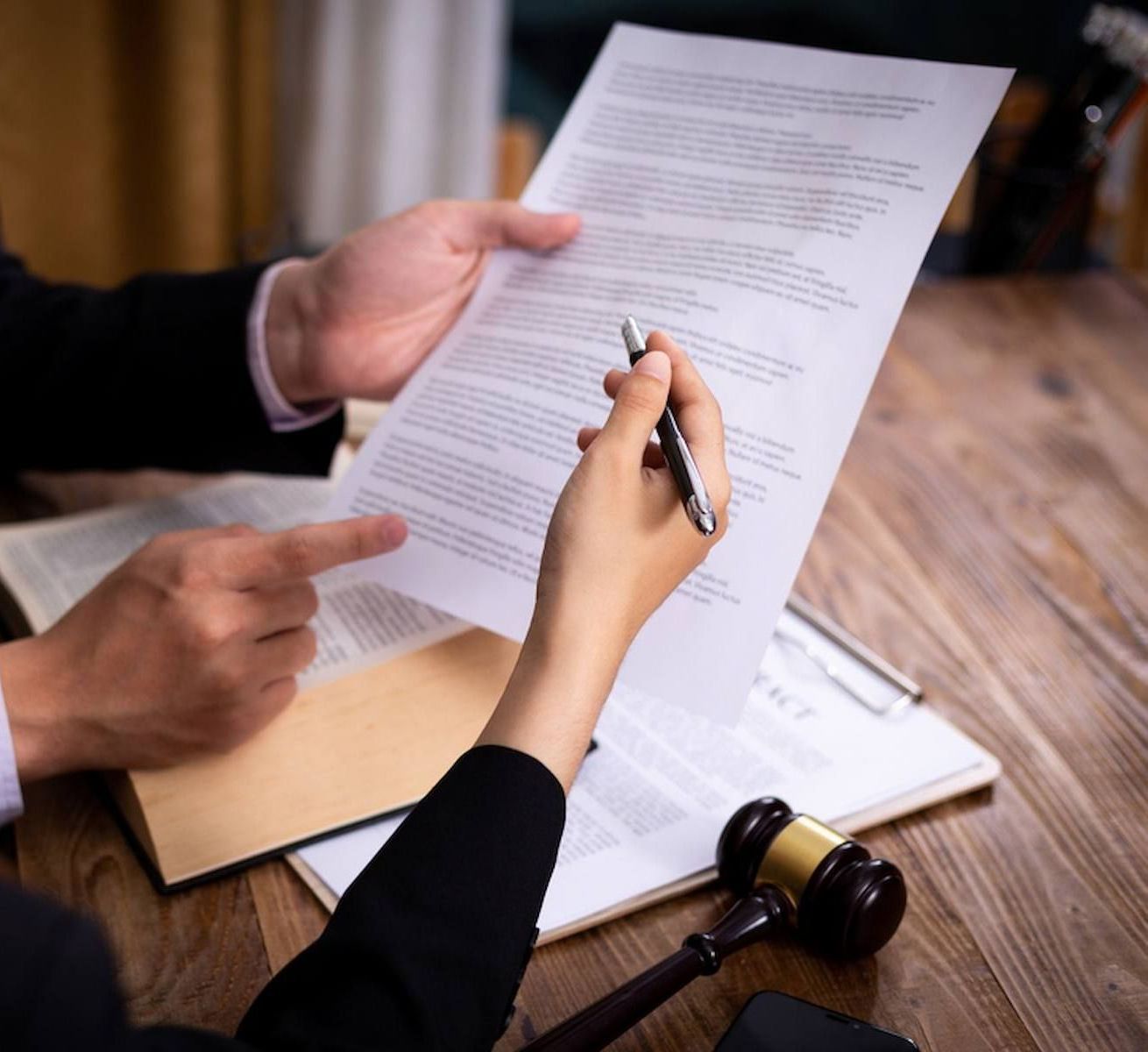 A Man And A Woman Are Sitting At A Table — Loretta Davison Financial Solutions In Shellharbour, NSW 