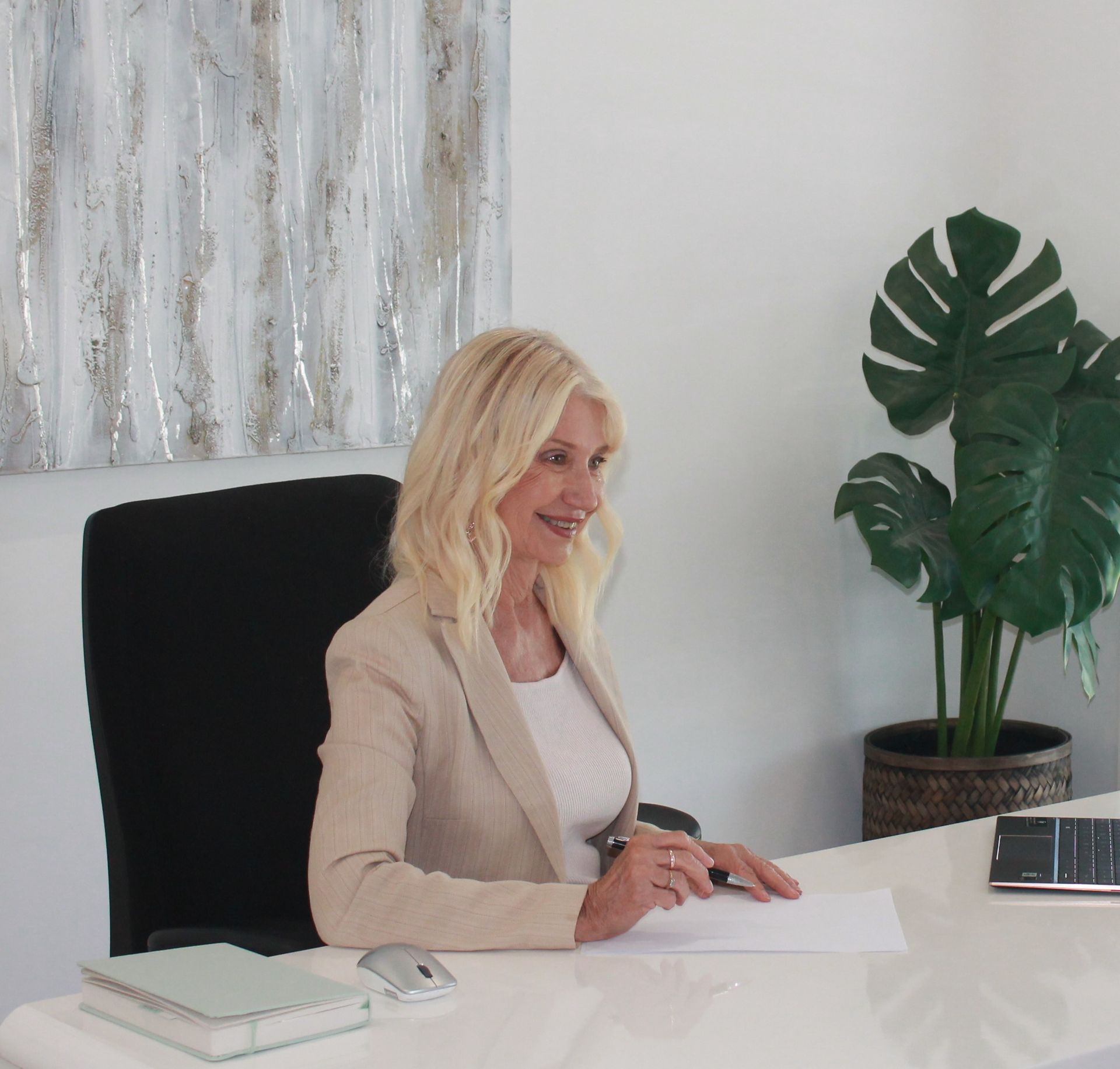 Three People Are Standing Around A Table In A Car Showroom — Loretta Davison Financial Solutions In Kiama, NSW 
