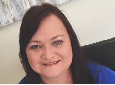 Woman Sitting At Office Desk — Loretta Davison Financial Solutions In Shellharbour, NSW