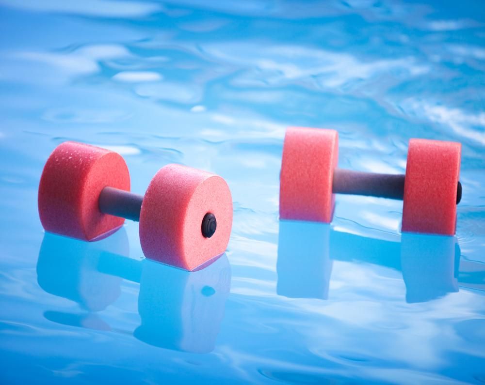 Two Red Foam Dumbbells Are Floating in a Swimming Pool — Whitsunday Pool Service in Cannonvale, QLD