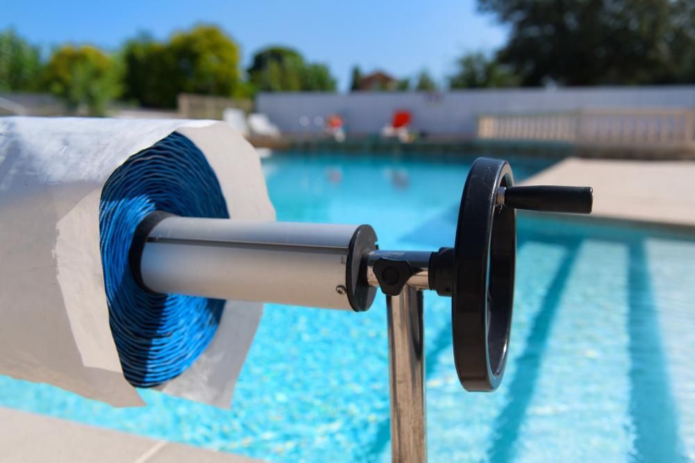 A Roll of Paper Towels is Sitting Next to a Swimming Pool — Whitsunday Pool Service in Proserpine, QLD