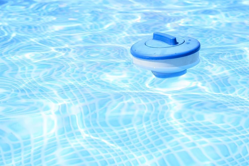 A Blue and White Floating Device is Floating in a Swimming Pool — Whitsunday Pool Service in Cannonvale, QLD