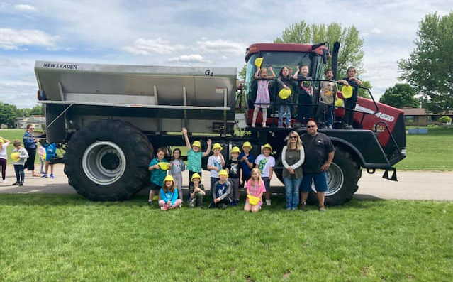 Tractor Spreading Artificial Fertilizers in Field — Sparta, WI — Wayne Bohl Trucking LLC