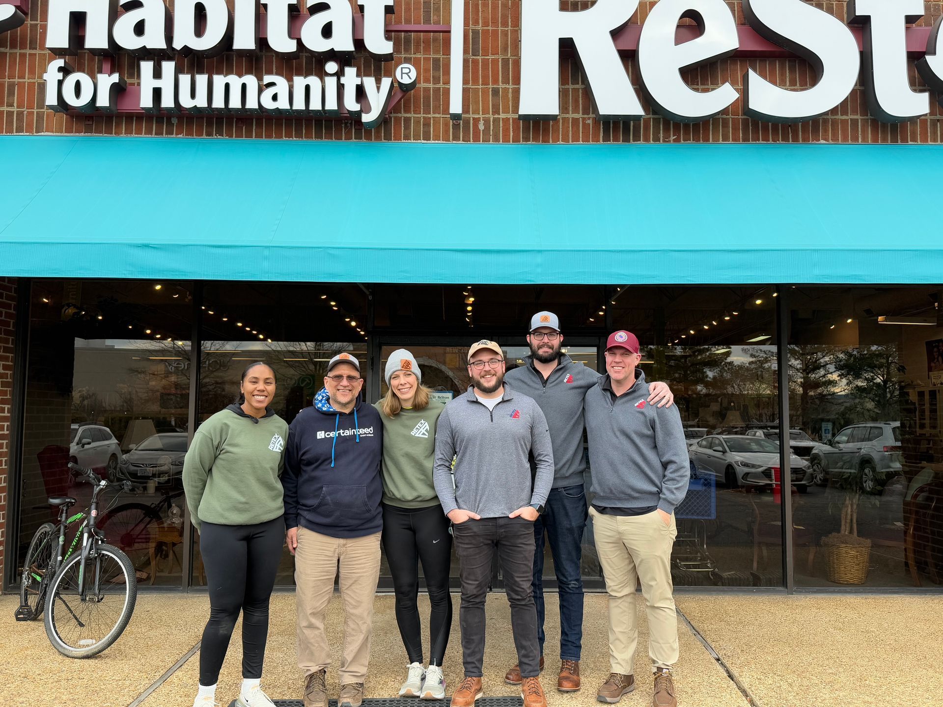 Image of RETEX’s Josh and Katelyn Lewis, Caleb Kammerling, Mark Erickson, and Caleb Hennon at Richmond Habitat for Humanity. 