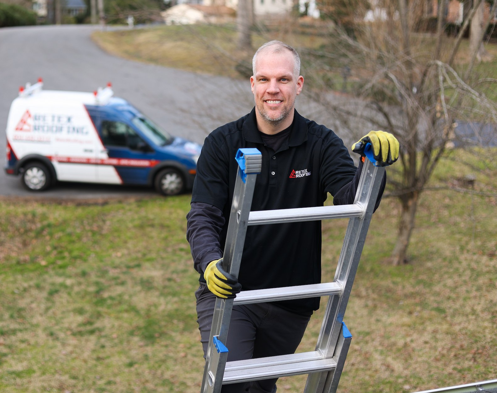 Portrait image of RETEX's Mark Erickson on ladder. RETEX van in background. 