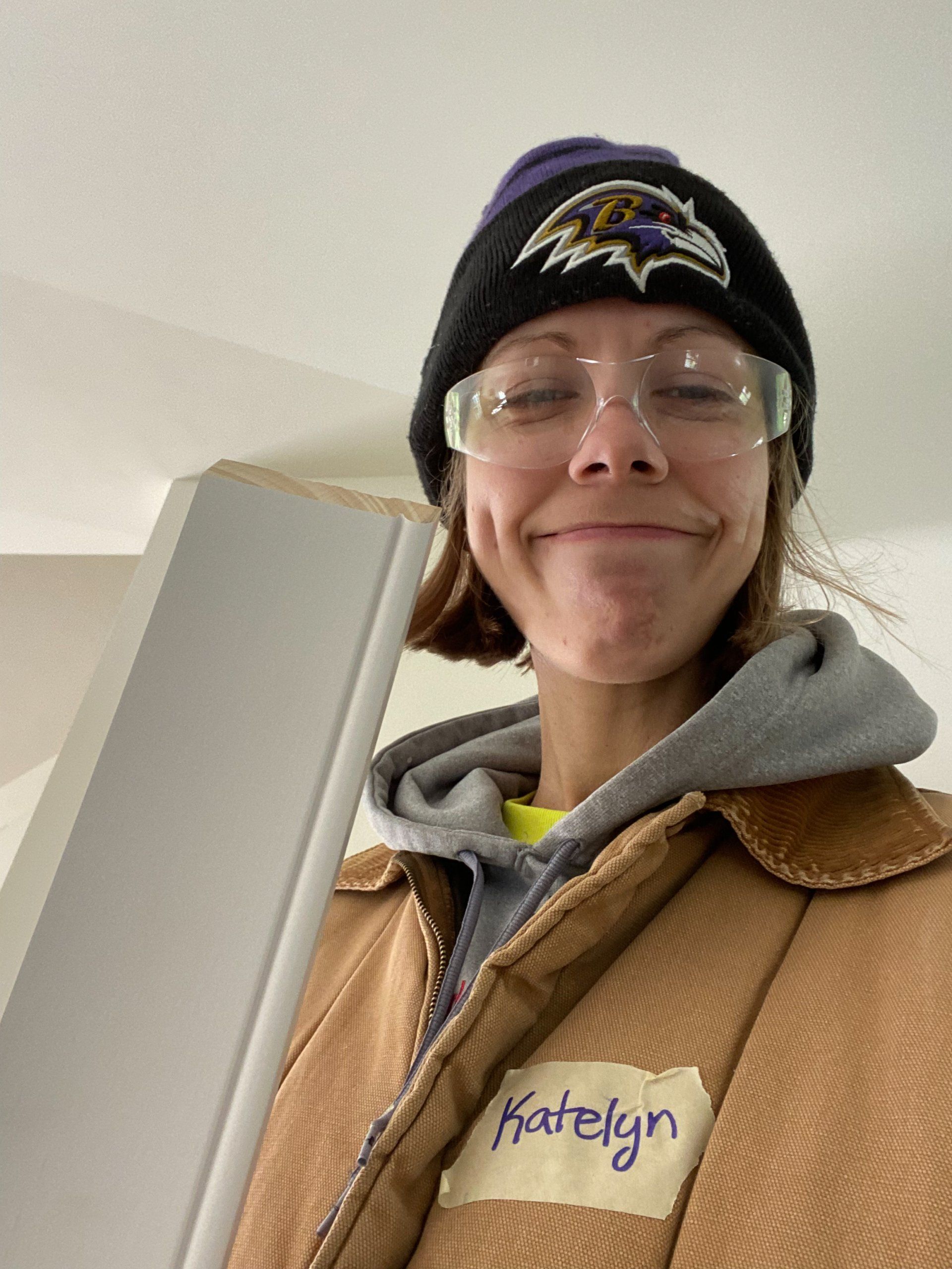 A selfie image of RETEX's Katelyn Lewis holding up trim during a Richmond Habitat volunteer day in November 2022. 